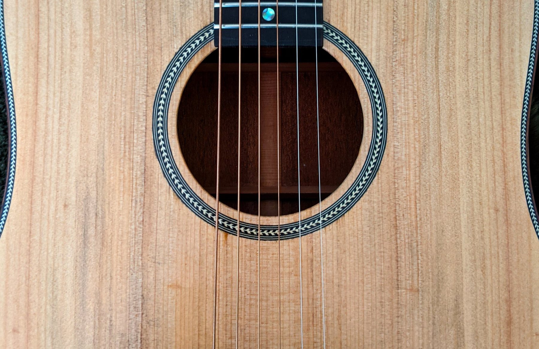 Macro detail of a herringbone rosette on a handmade acoustic guitar